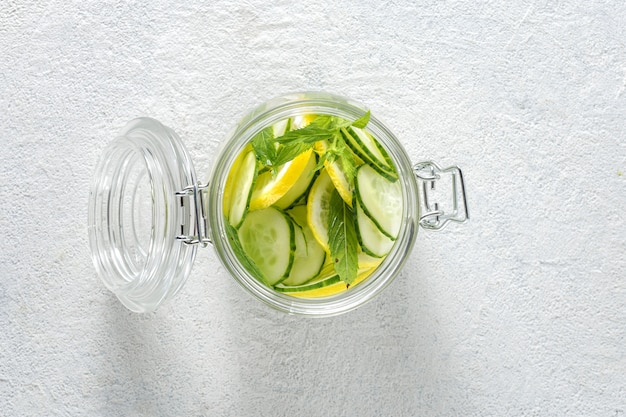 Detox drink cucumber water in the glass top view. diet concept