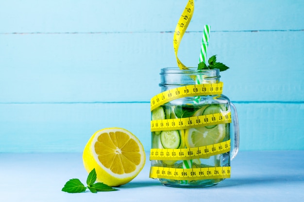 Detox drink juicy lemon, mint and measuring tape 