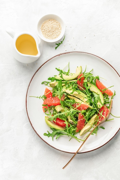 Detox grapefruit and arugula salad, top down close-up view