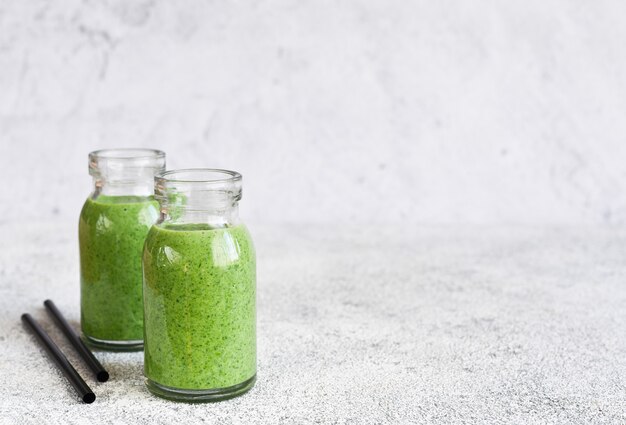 Detox green smoothie with spinach in jar