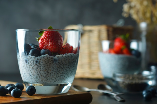 Detox and healthy breakfast chia seeds pudding with strawberries and blueberries.