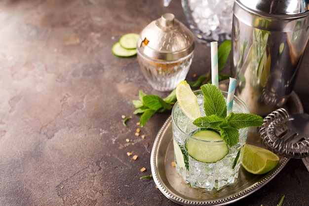 Detox infused cucumber water. Refreshing summer homemade cocktail on stone background