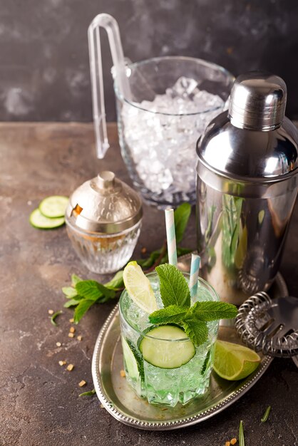 Detox infused cucumber water. Refreshing summer homemade cocktail on stone background