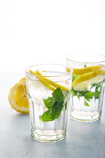 Detox lemon ice and mint drink or mojito with spring color