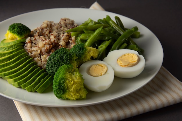 Detox salad bowl with quinoa and green vegetables - green peas, avocado, broccoli and eggs. 