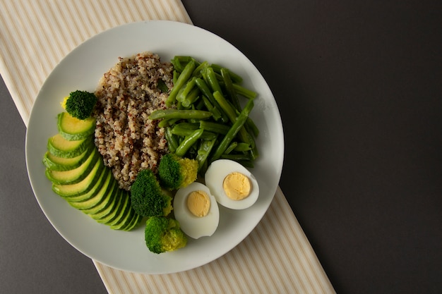 Detox salad bowl with quinoa and green vegetables - green peas, avocado, broccoli and eggs. 