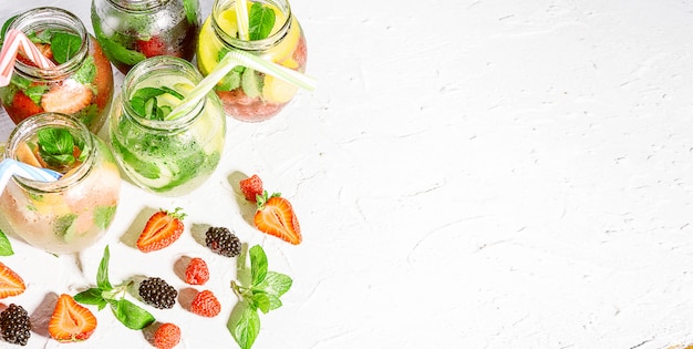 Detox smoothies of fresh fruits and vegetables in glass jars with tubes