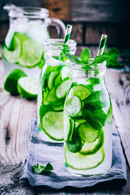 Detox water with cucumber lime and mint in bottles