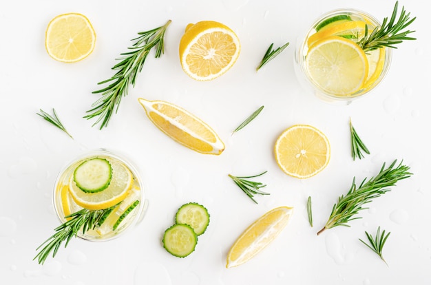 Detox water with lemon, cucumber and rosemary on white background