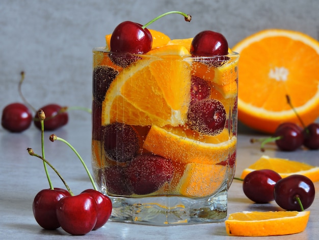 Detox water with orange and cherries.