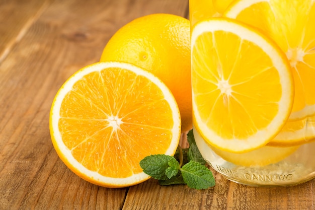 Detox water with orange slices in a glass jar close-up