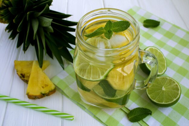 Detox water with pineapple and lime on the green napkin