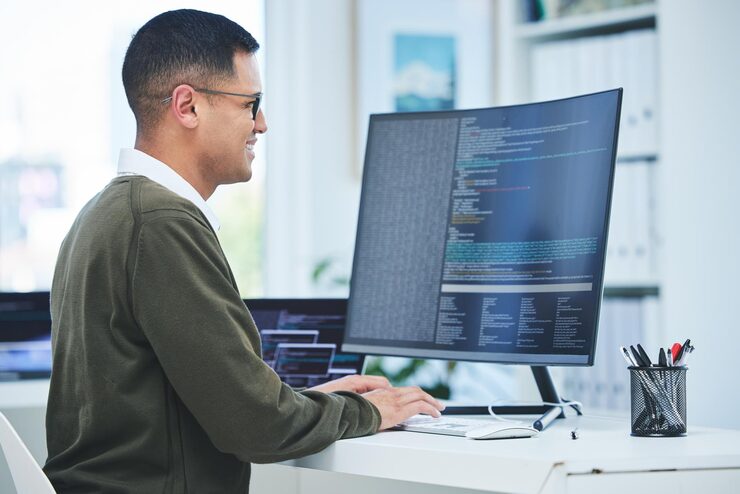 Photo developer programming and a man at computer for coding software script or cyber security in office happy it technician person or programmer with technology for code future and data analytics