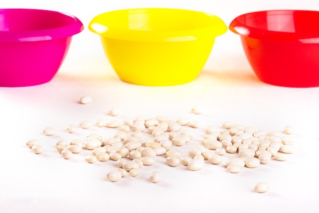 Developing lessons for young children The development of fine motor skills Haricot beans and colored plastic bowl