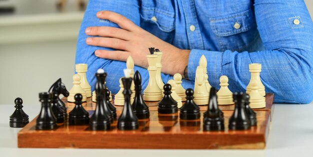 Photo development logics. learning play chess. bad move nullifies good ones. figures on wooden chess board. thinking about next step. chess lesson. strategy concept. playing chess. intellectual hobby.