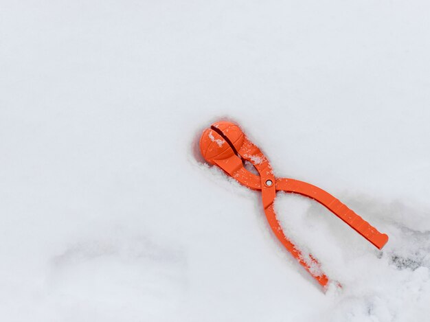 Device for making snowballs on white snow. winter kids games