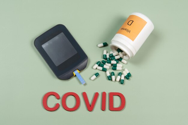 Device to measure blood glucose and the word Covid written