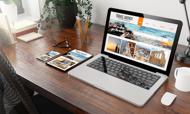 Devices travel agency on wooden desktop