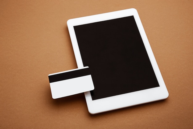 Devices with blank screens floating above brown background Phone tablet card