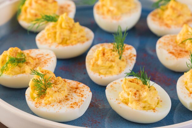 Deviled eggs garnished with fresh dill.