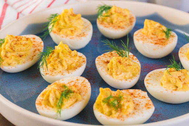 Deviled eggs garnished with fresh dill.