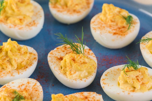 Deviled eggs garnished with fresh dill.