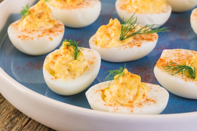 Deviled eggs garnished with fresh dill.