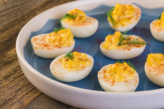 Deviled eggs garnished with fresh dill.