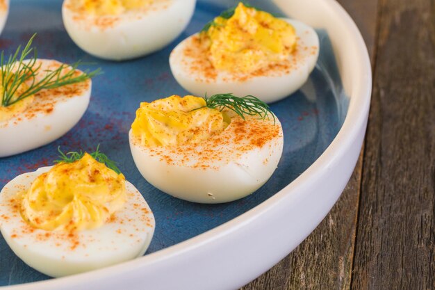 Deviled eggs garnished with fresh dill.