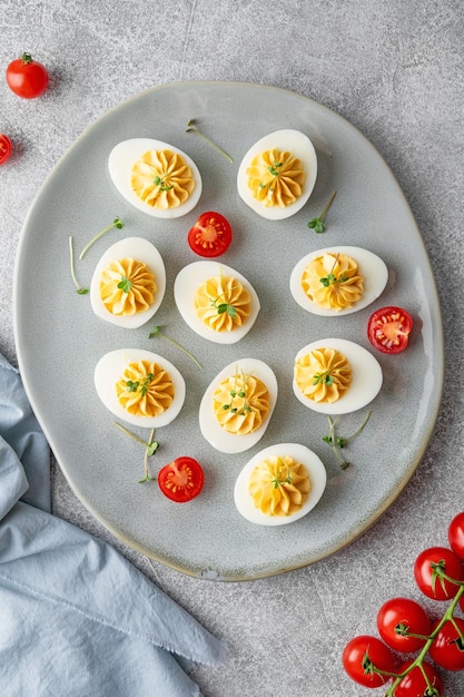 Deviled eggs with cheese mustard and microgreens on top on a plate for Easter