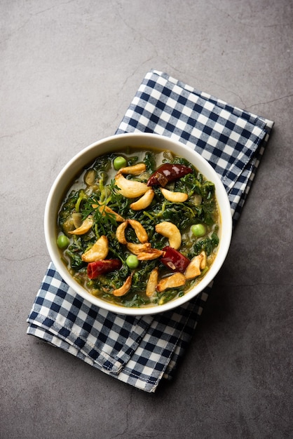 Dhaba Style Lasuni or Lasooni Methi fry sabzi made using fresh fenugreek leaves, onion and garlic mixed with Indian spices, served in a bowl