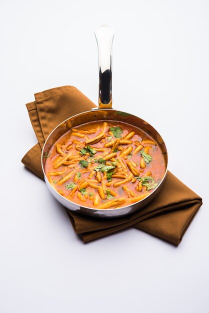 Dhaba style Sev bhaji, sabzi, curry made in tomato curry with gathiya or ganthia shev, served in a bowl or karahi, selective focus