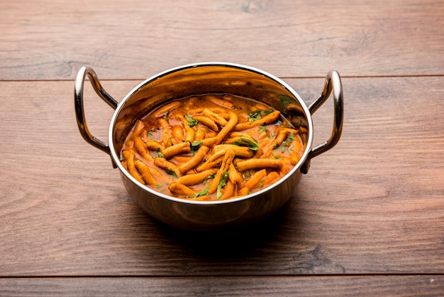 Dhaba style Sev bhaji, sabzi, curry made in tomato curry with gathiya or ganthia shev, served in a bowl or karahi, selective focus