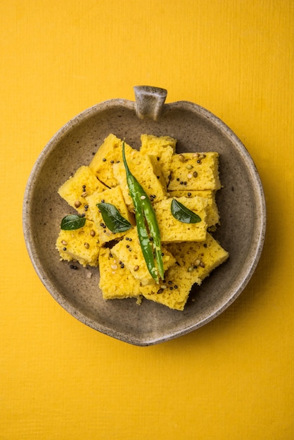 Dhokla is a veg food or snack breakfast item from indian state\
of gujarat. served with chutney & chilli