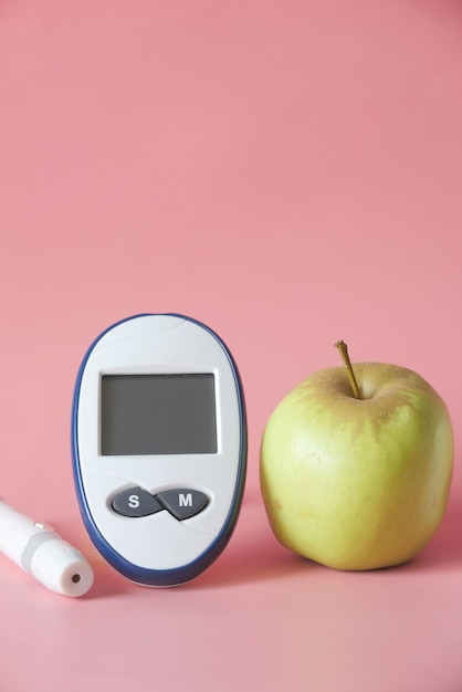 diabetic measurement tools, apple on table