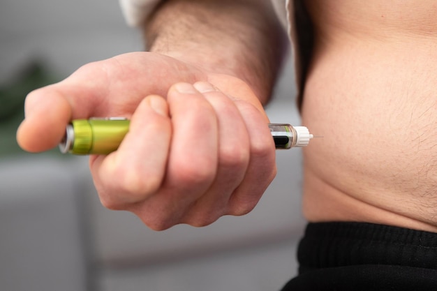 A diabetic patient using insulin pen for making an insulin injection at home