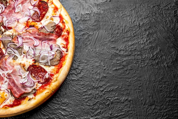 DIABLO pizza on a black background, tomato-based Pizza with mozzarella