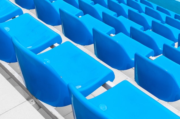 Diagonal view of bright blue single seats to watch sport competition