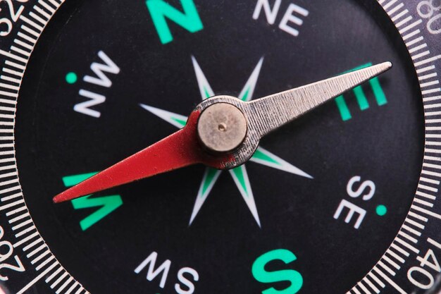 Photo dial compass in closeup arrow indicates direction west