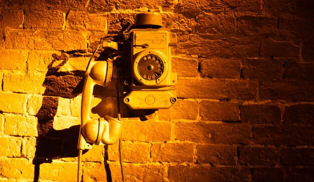 Dialing back time vintage telephone resting on brick