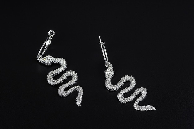 Diamond earrings jewelry luxury silver and gold earrings with diamonds sapphires in black background