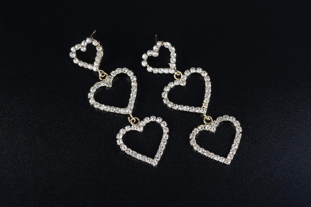 Diamond earrings jewelry luxury silver and gold earrings with diamonds sapphires in black background