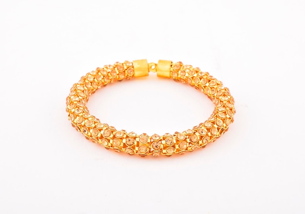 Diamond and gold bangle on white background