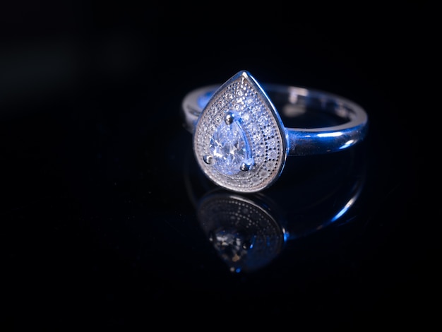 Diamond ring on black table