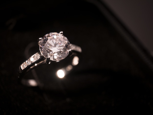 Diamond ring on black table