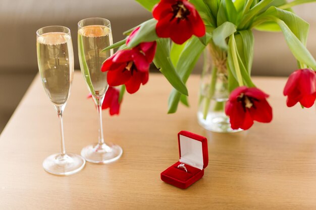 diamond ring champagne and flowers on table