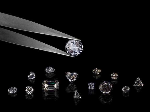 Diamond in tweezers on a black background with diamonds group soft focusing