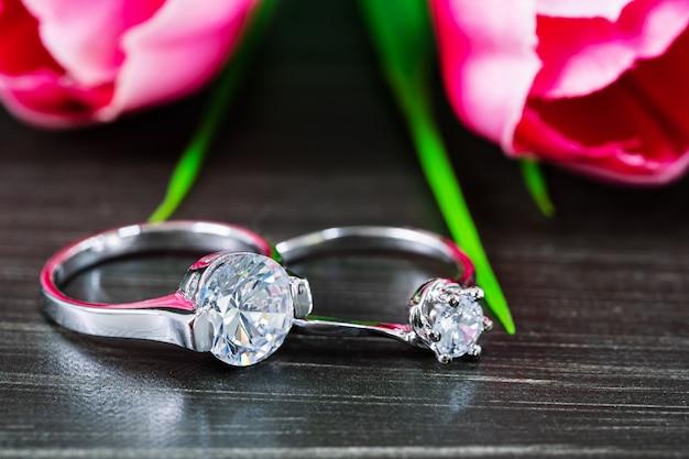 Diamond wedding rings with tulip flower on black   