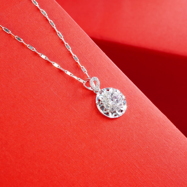 diamonds necklace shot against a red background