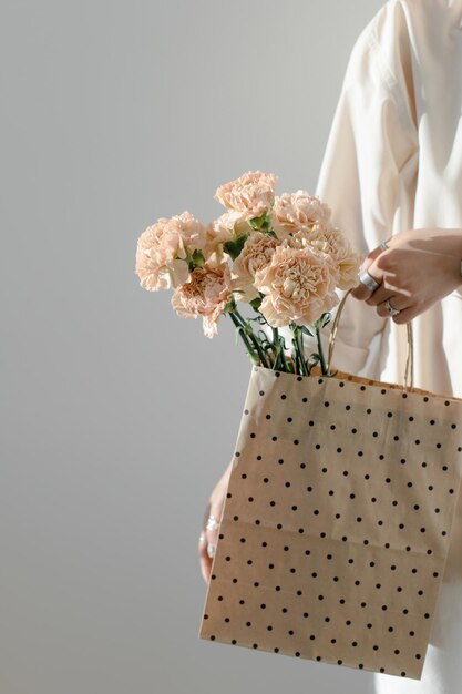 Dianthus flowers in a kraft bag with a box